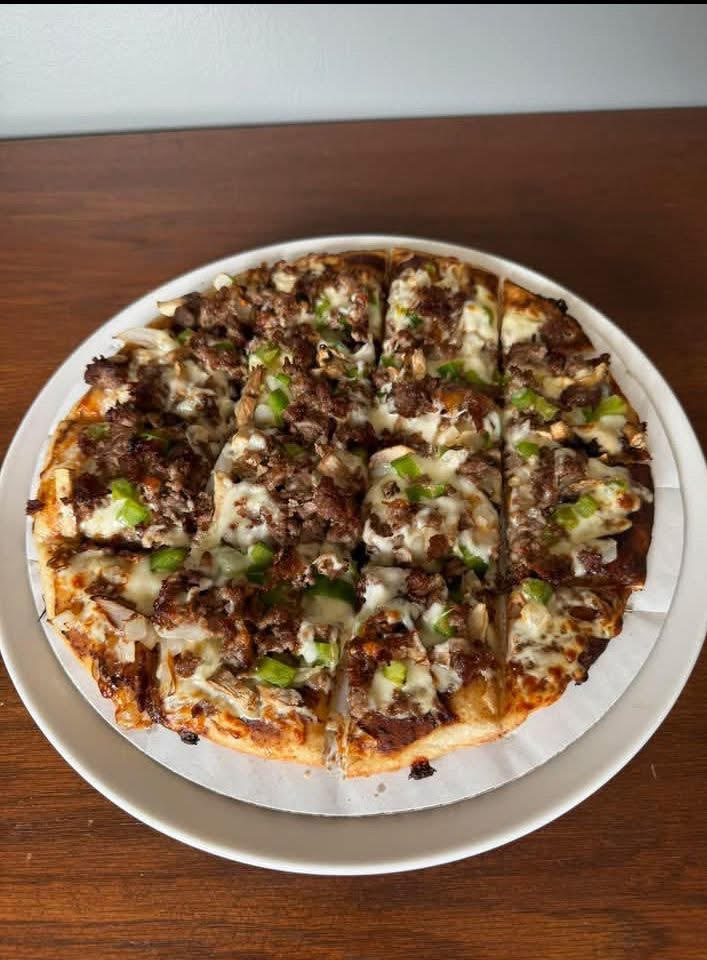 pizza topped with cheese, steak, BBQ, onions, and mushrooms